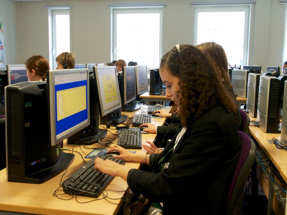  students working on computer desk